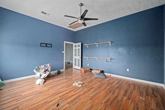 interior space featuring ceiling fan, hardwood / wood-style floors, a textured ceiling, and french doors