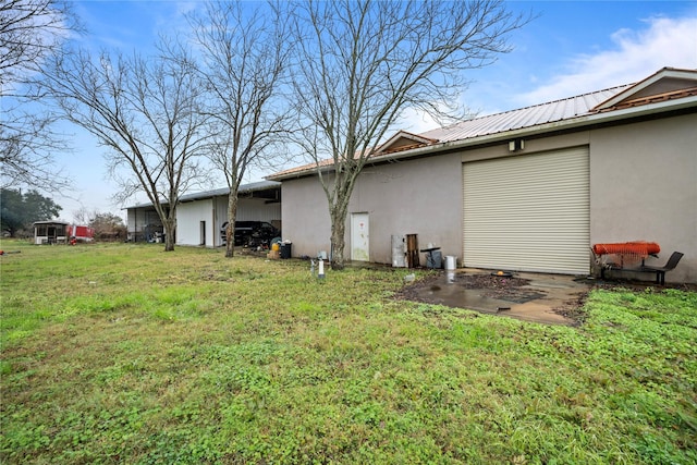 view of property exterior featuring a garage and a yard