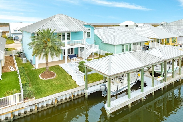 view of dock featuring a yard and a water view