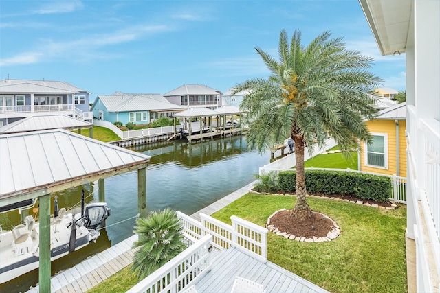 view of dock featuring a lawn and a water view