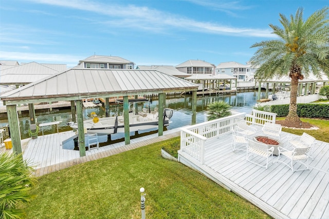 dock area featuring a yard, a fire pit, and a water view