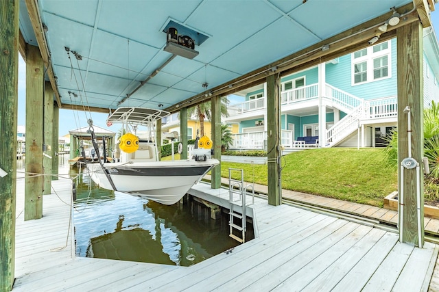 dock area featuring a lawn and a water view