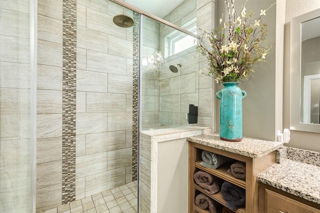 bathroom with vanity and a shower with shower door