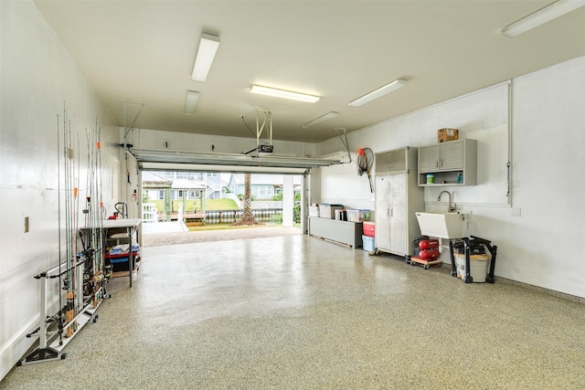 garage featuring sink and a garage door opener