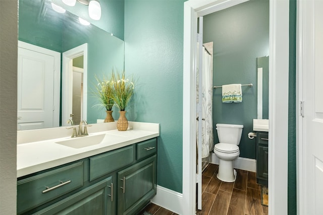 bathroom with walk in shower, vanity, and toilet