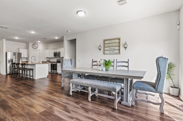 dining room featuring dark wood-type flooring, recessed lighting, and visible vents