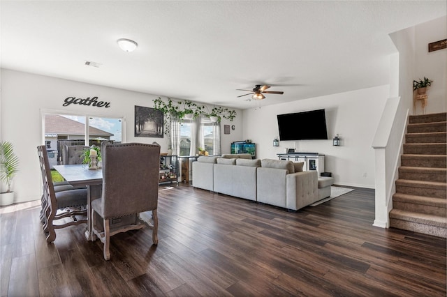 dining area with visible vents, stairway, dark wood finished floors, and a ceiling fan