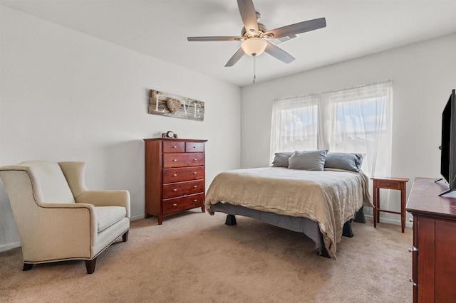 bedroom featuring light carpet, a ceiling fan, and baseboards