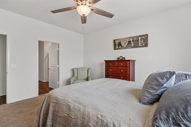 bedroom with ceiling fan, carpet flooring, and baseboards