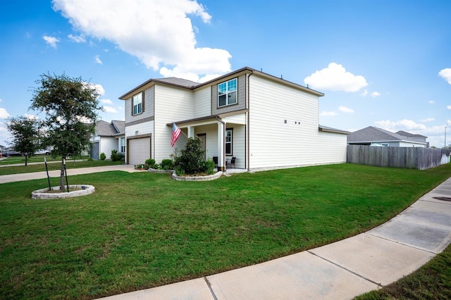 view of front facade with a front yard, concrete driveway, fence, and an attached garage