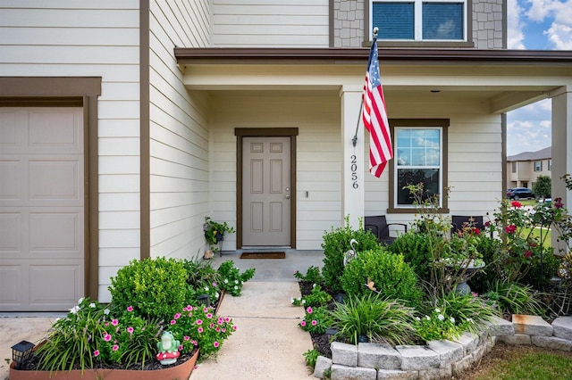 entrance to property with a garage and a porch