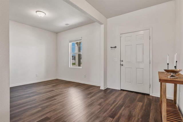 entrance foyer featuring visible vents, baseboards, and dark wood-style flooring