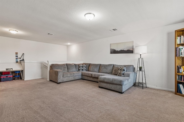 carpeted living area with visible vents, a textured ceiling, and baseboards