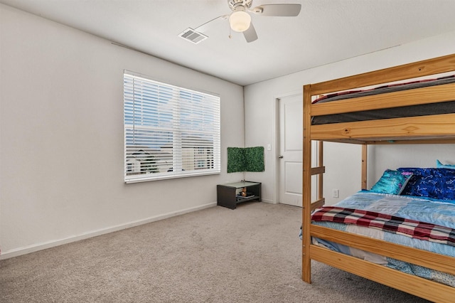 carpeted bedroom featuring ceiling fan, visible vents, and baseboards