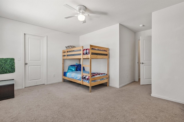 bedroom with ceiling fan, carpet flooring, and baseboards