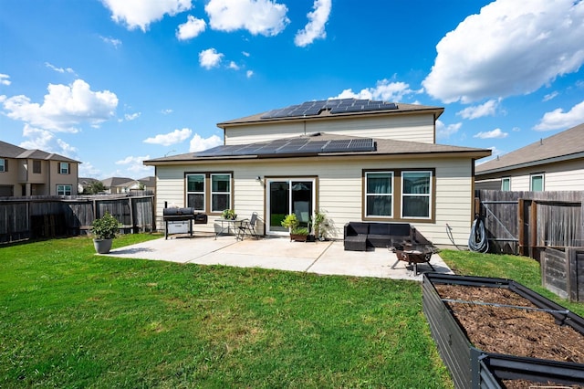 rear view of house with a patio area, a vegetable garden, and a lawn