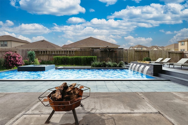 view of pool featuring a patio, an outdoor fire pit, a fenced backyard, an in ground hot tub, and a fenced in pool