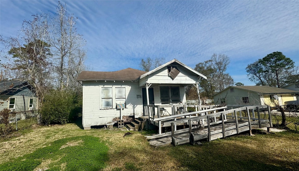 back of house with a lawn