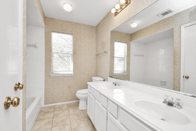 bathroom with a healthy amount of sunlight, tile patterned floors, and toilet