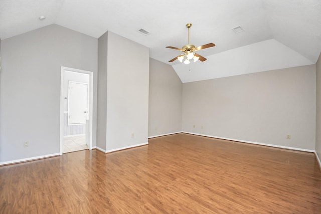 interior space with lofted ceiling, hardwood / wood-style floors, and ceiling fan