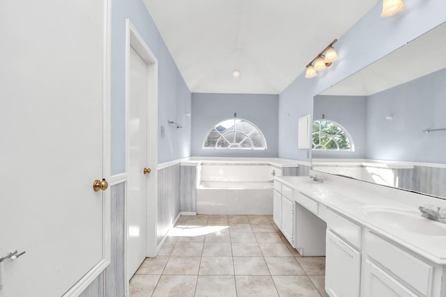 bathroom with a bathtub, tile patterned flooring, and vanity