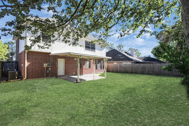 back of house with a lawn, central AC, and a patio