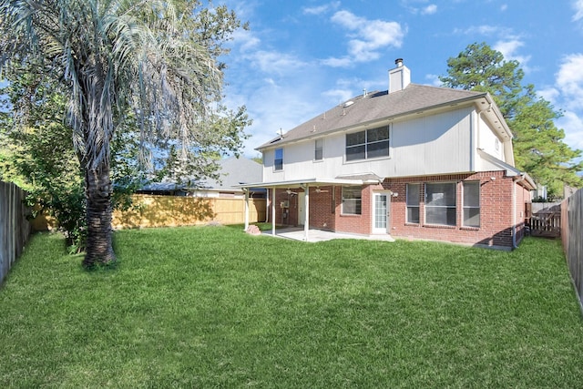 rear view of house featuring a patio area and a lawn