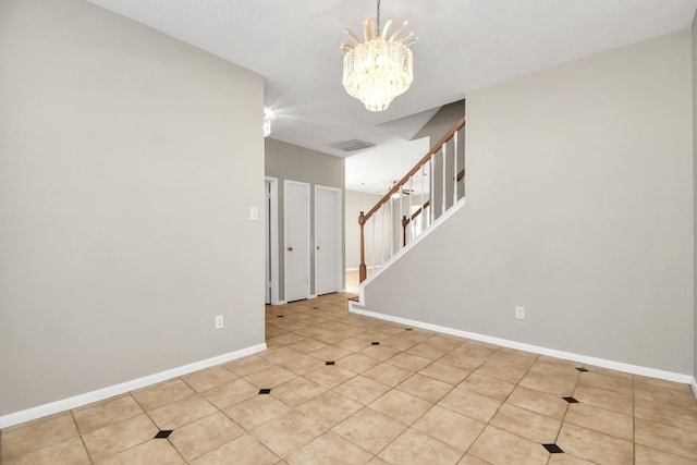 unfurnished room featuring an inviting chandelier and light tile patterned floors