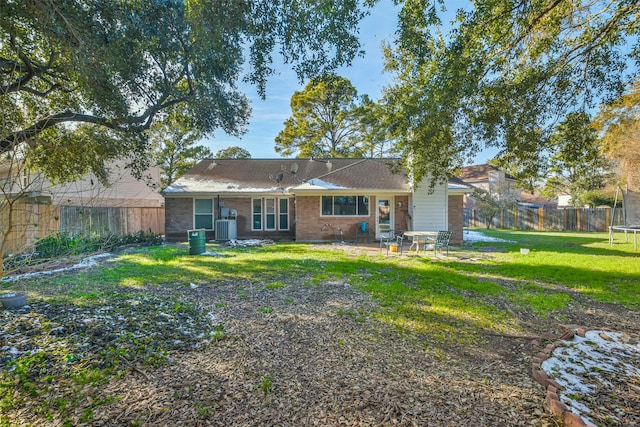 16002 Maple Acres Ct, Houston, TX 77095 - back of property with a trampoline, a fenced backyard, and brick siding