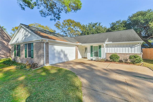 ranch-style house featuring a front yard and a garage