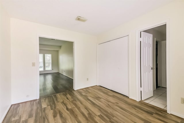 16002 Maple Acres Ct, Houston, TX 77095 - unfurnished bedroom with wood finished floors and a closet
