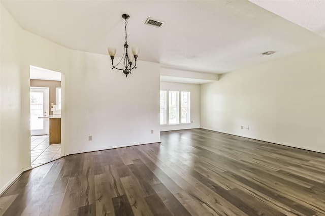16002 Maple Acres Ct, Houston, TX 77095 - spare room with a chandelier, dark wood-style floors, and healthy amount of natural light