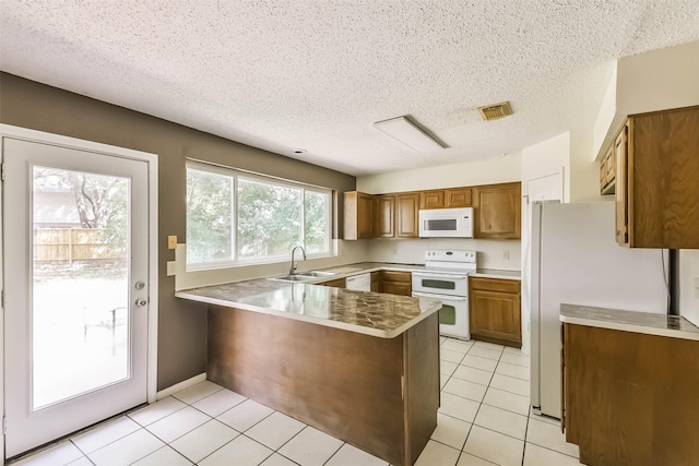 16002 Maple Acres Ct, Houston, TX 77095 - kitchen featuring white appliances, a peninsula, brown cabinets, a textured ceiling, and light tile patterned floors