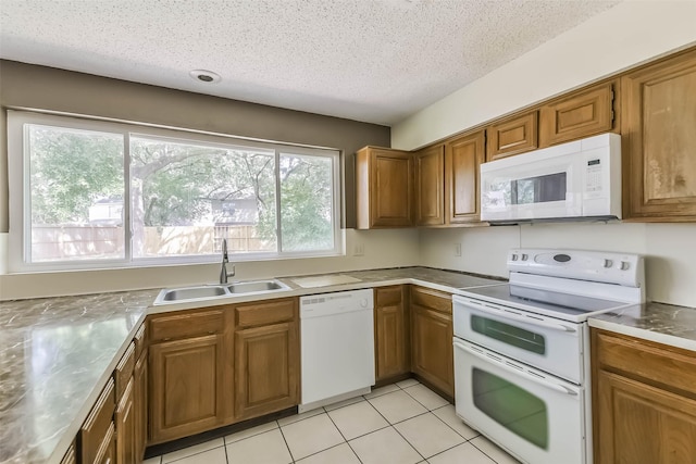 16002 Maple Acres Ct, Houston, TX 77095 - kitchen featuring white appliances, brown cabinetry, a textured ceiling, light tile patterned floors, and light countertops