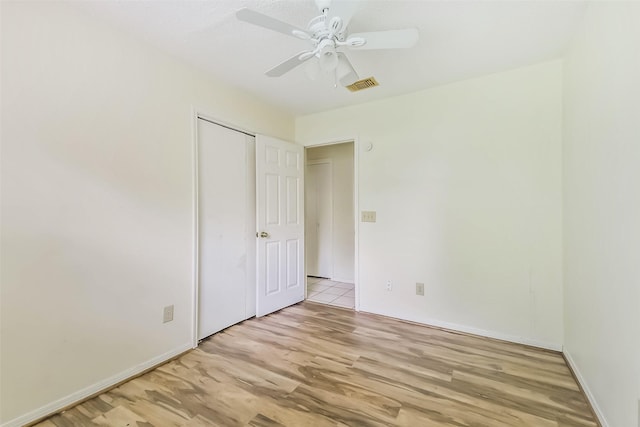 16002 Maple Acres Ct, Houston, TX 77095 - unfurnished bedroom featuring light wood-style flooring, a ceiling fan, and a closet