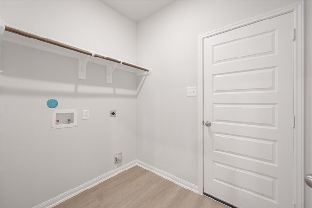 clothes washing area featuring hookup for an electric dryer, light hardwood / wood-style flooring, and washer hookup