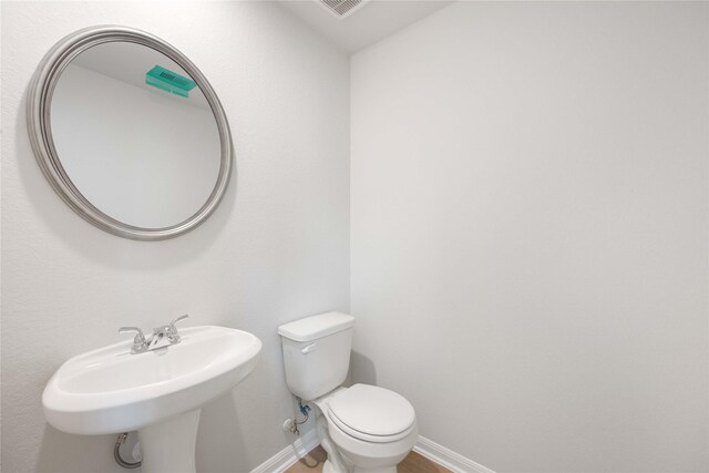 bathroom with toilet and sink