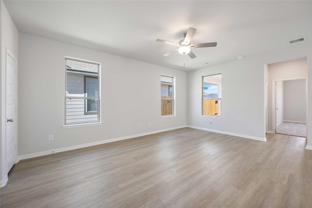 spare room with light wood-type flooring and ceiling fan