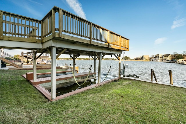 view of dock with a yard and a water view