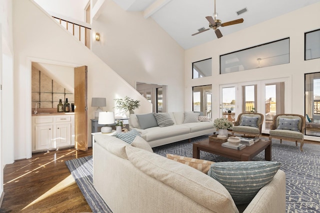 living room featuring high vaulted ceiling, wet bar, ceiling fan, and beam ceiling