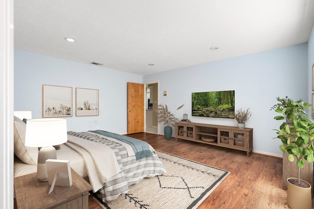 bedroom with hardwood / wood-style flooring