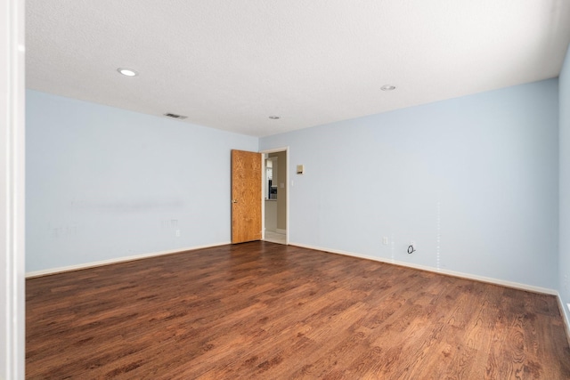 spare room featuring dark hardwood / wood-style floors