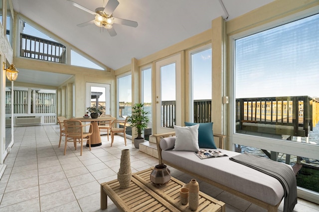 sunroom featuring lofted ceiling, ceiling fan, and a healthy amount of sunlight