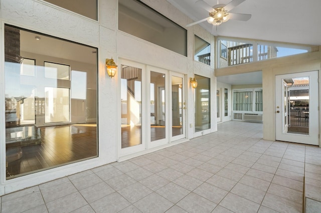 unfurnished sunroom featuring lofted ceiling and ceiling fan