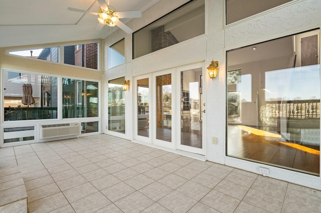 unfurnished sunroom featuring ceiling fan and vaulted ceiling