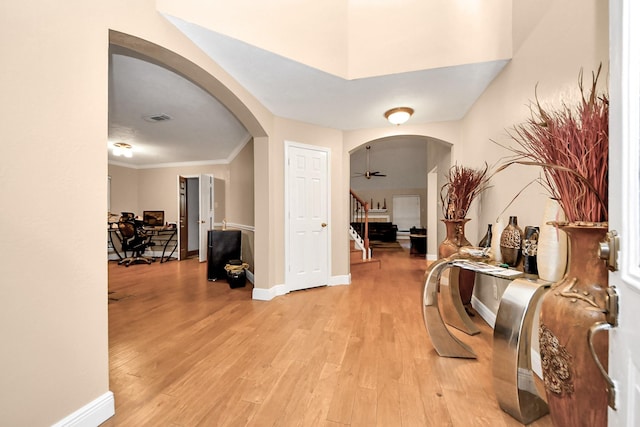 hall featuring crown molding and light hardwood / wood-style flooring