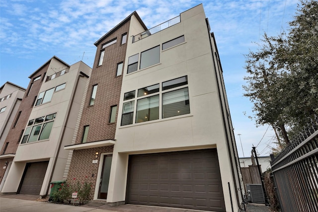 exterior space with a garage and central air condition unit