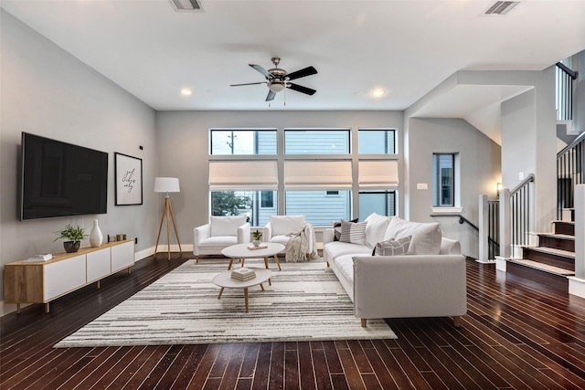 living room with ceiling fan and dark hardwood / wood-style flooring