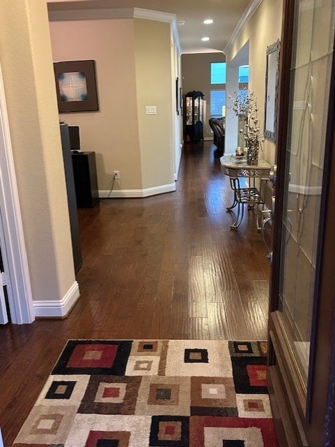 corridor featuring crown molding and dark hardwood / wood-style floors