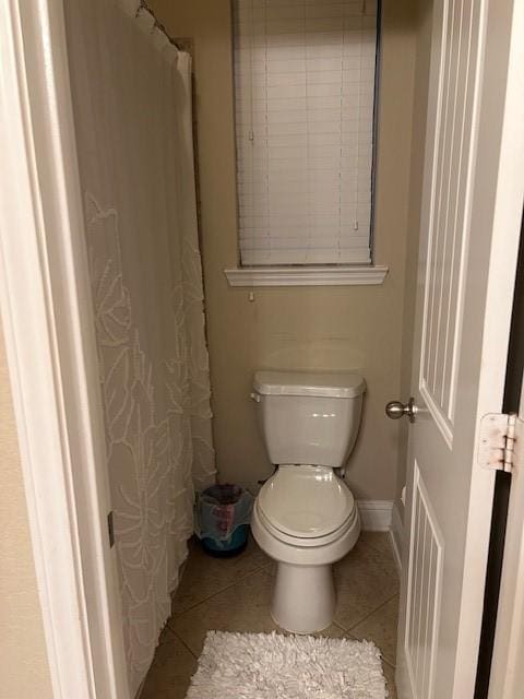 bathroom with toilet and tile patterned flooring